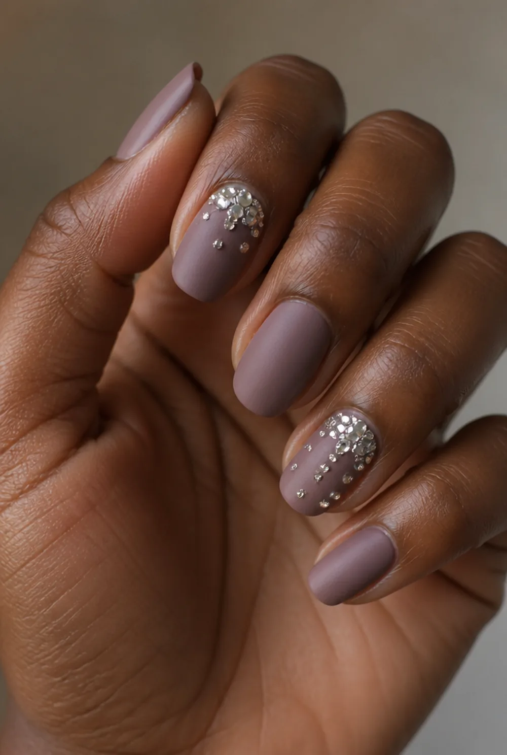 matte with rhinestone accent nail art on deep brown skin