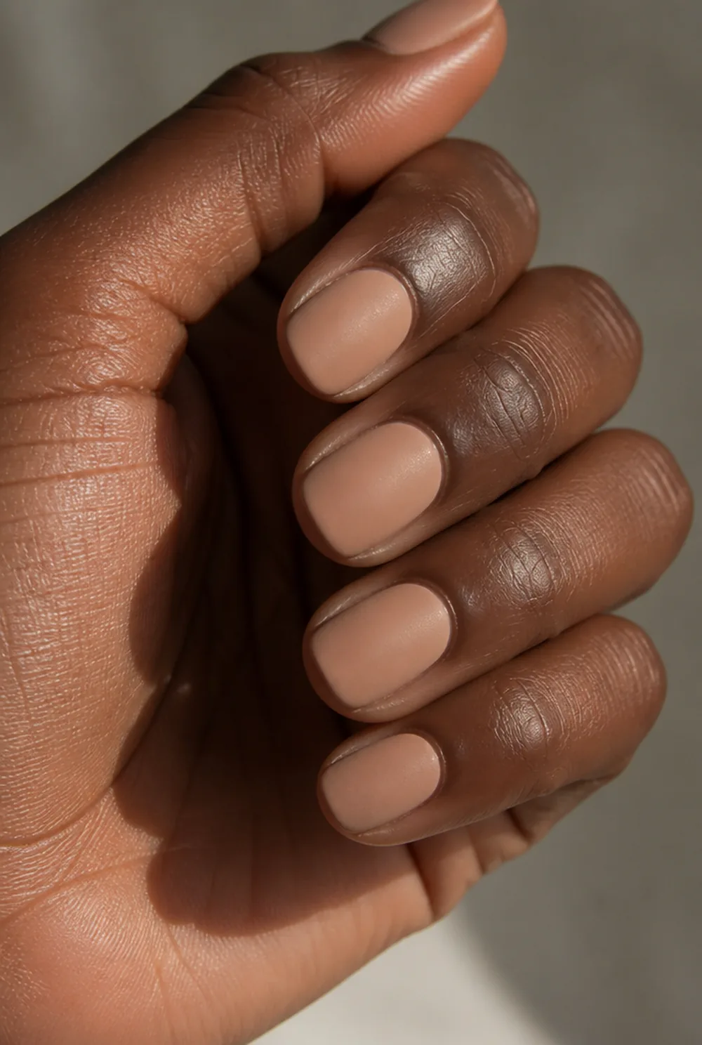 matte nude nail art on deep brown skin