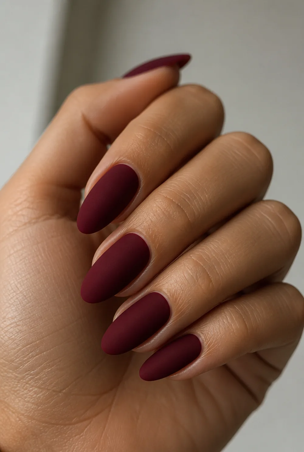 matte burgundy nail art on olive skin, long length