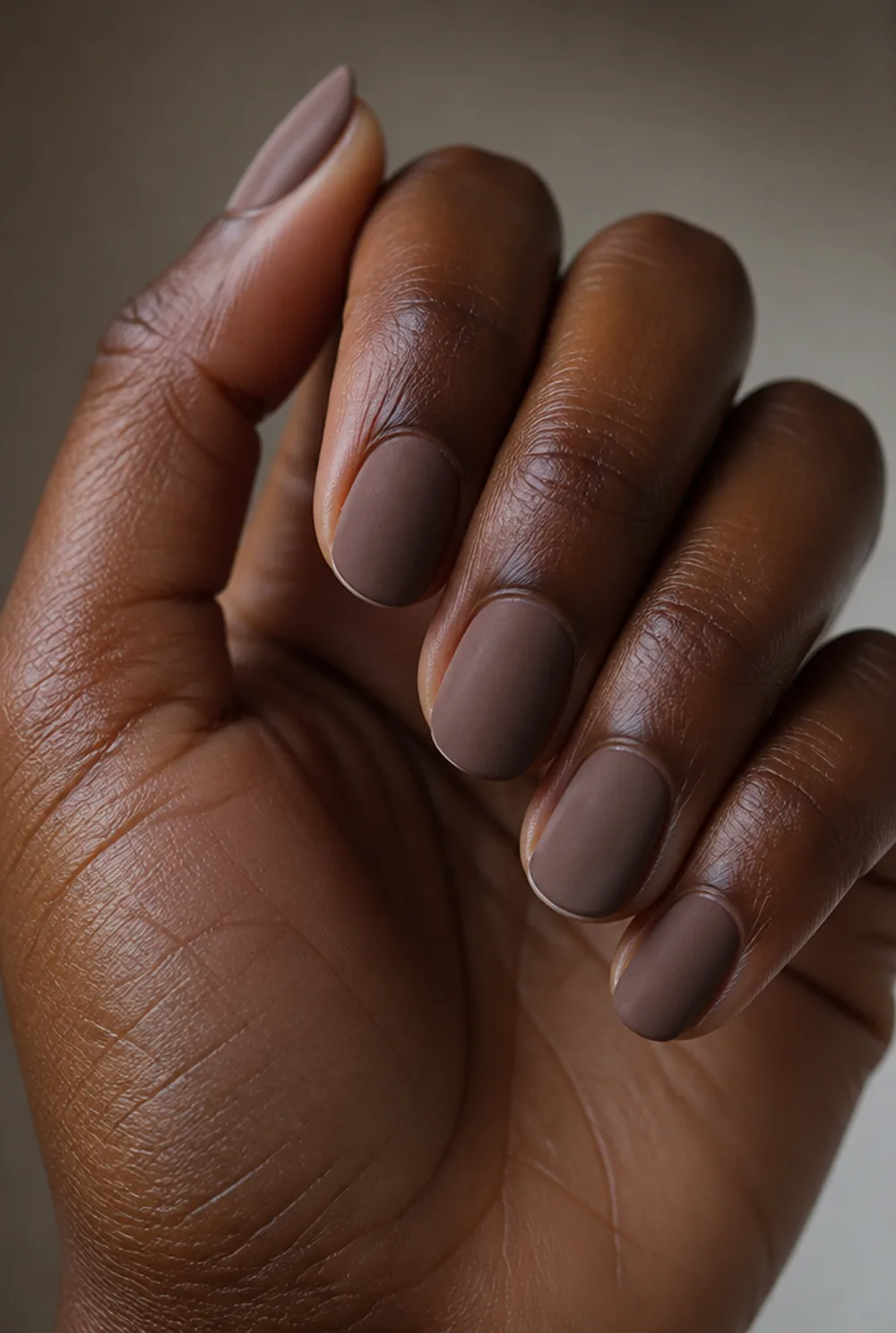 matte taupe suede nail art on deep brown skin