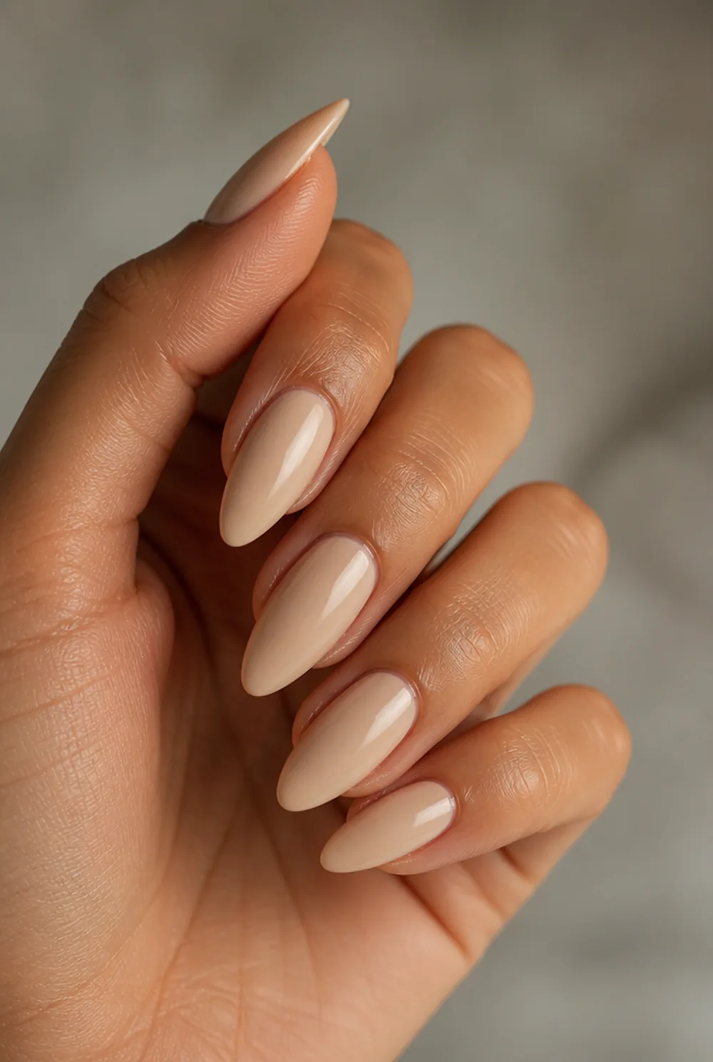 medium almond nude nail art on olive skin, long length