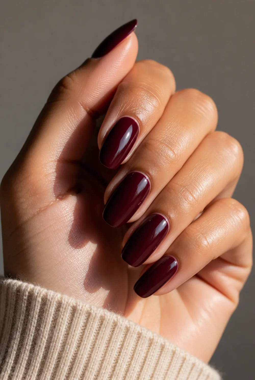 medium burgundy nail art on olive skin, long length