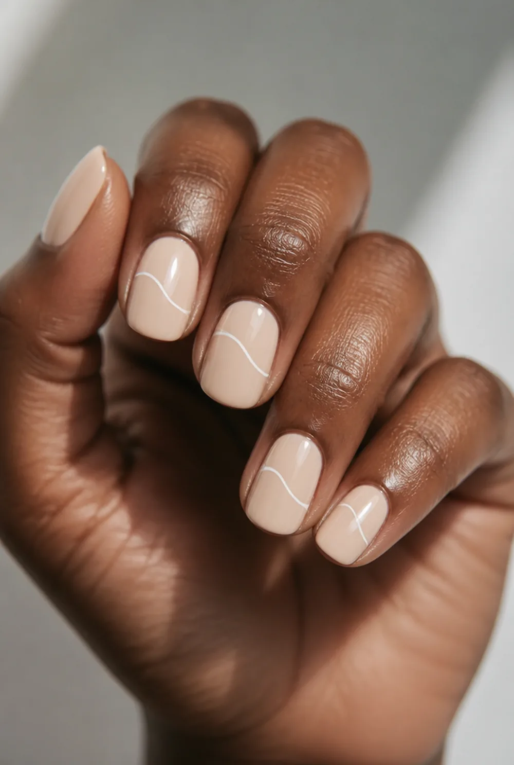 medium swirl nail art on deep brown skin