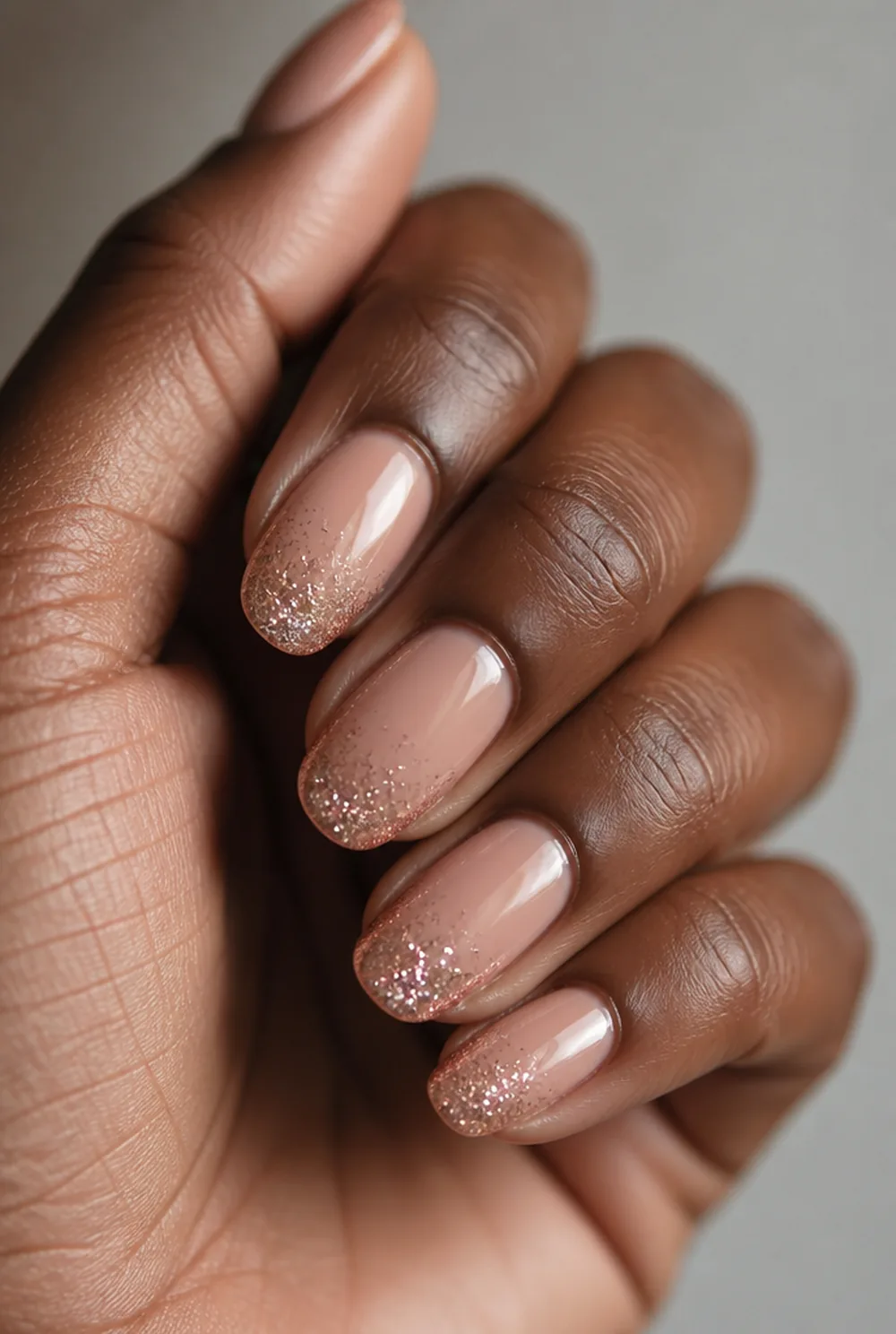 medium glitter tip nail art on deep brown skin