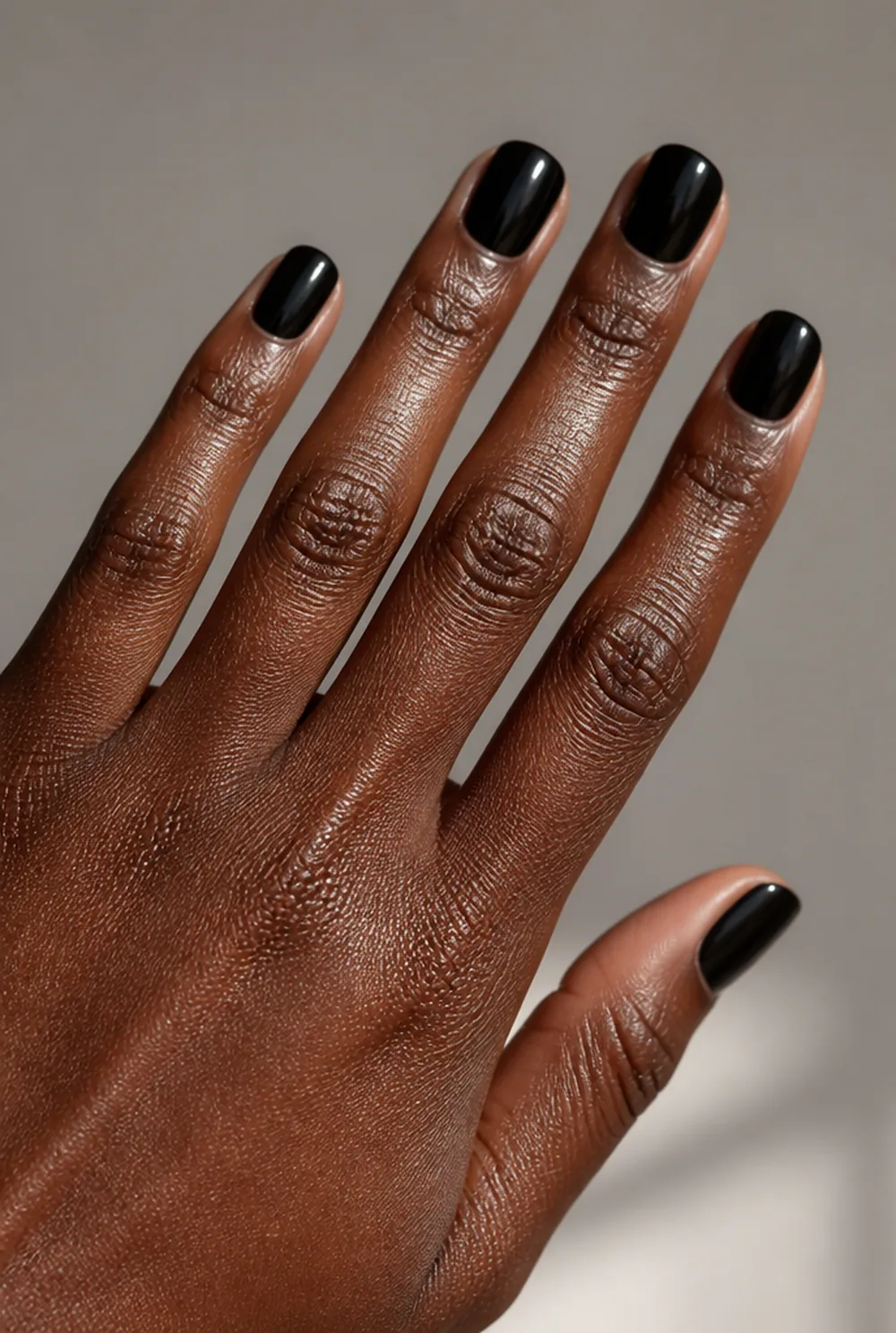 medium black gloss nail art on deep brown skin
