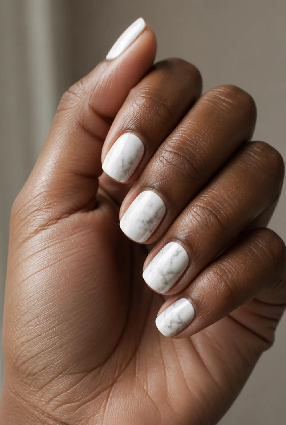 medium marble nail art on deep brown skin