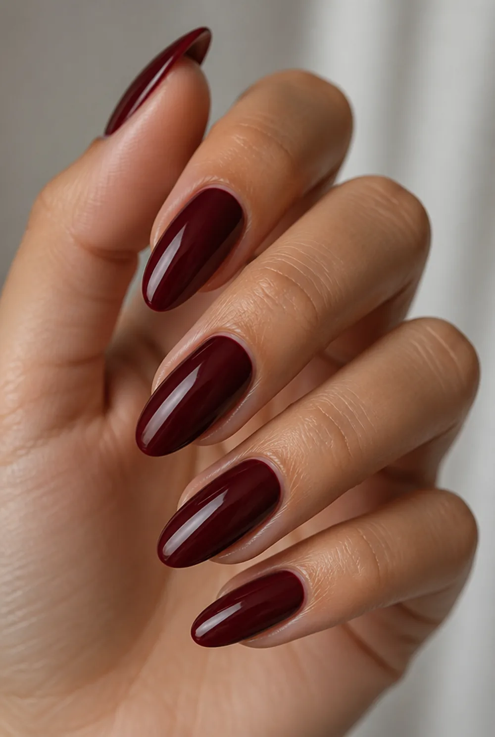medium blackened cherry nail art on olive skin, long length