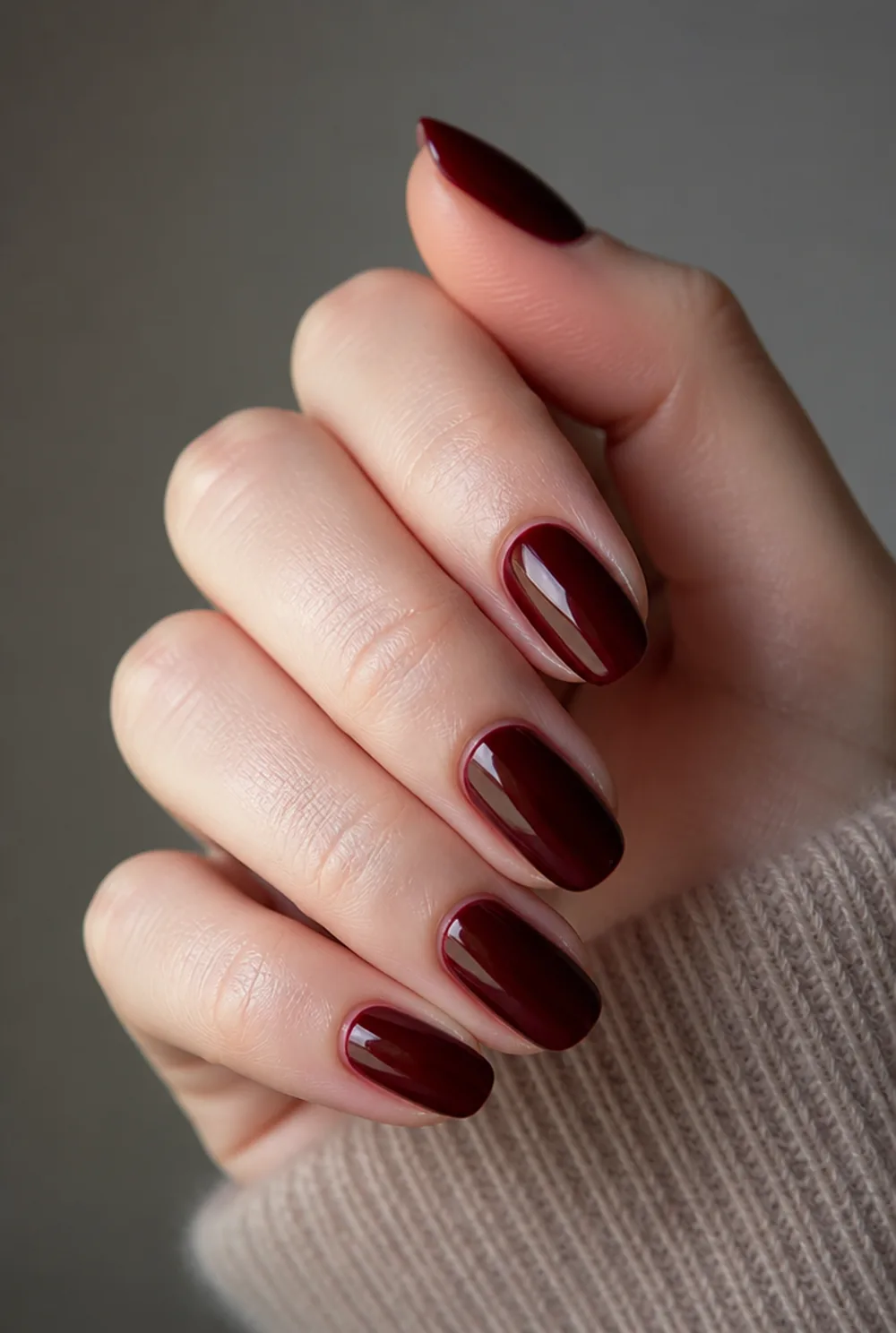 medium blackened cherry nail art on fair skin, short length