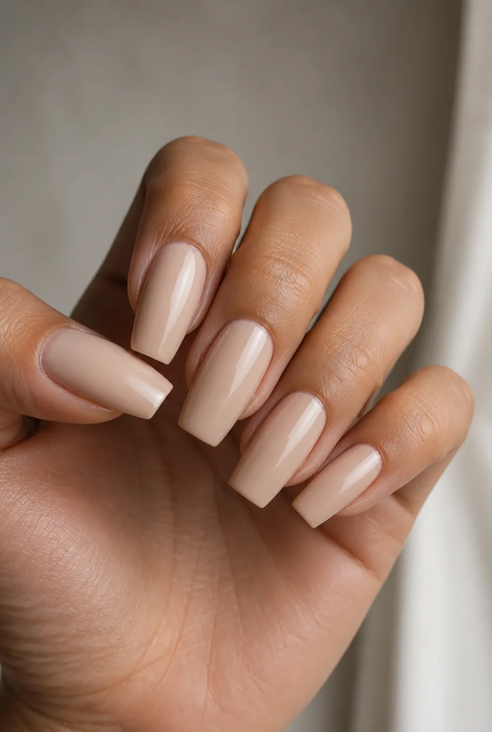medium coffin nude nail art on olive skin, long length