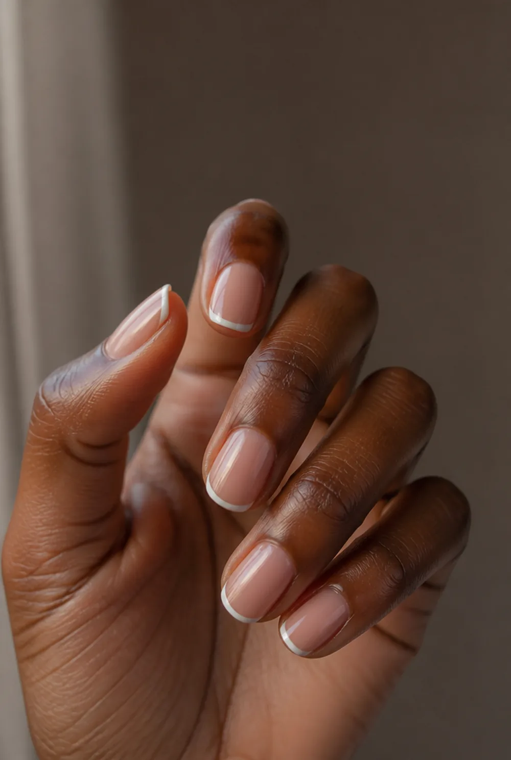 medium micro french nail art on deep brown skin