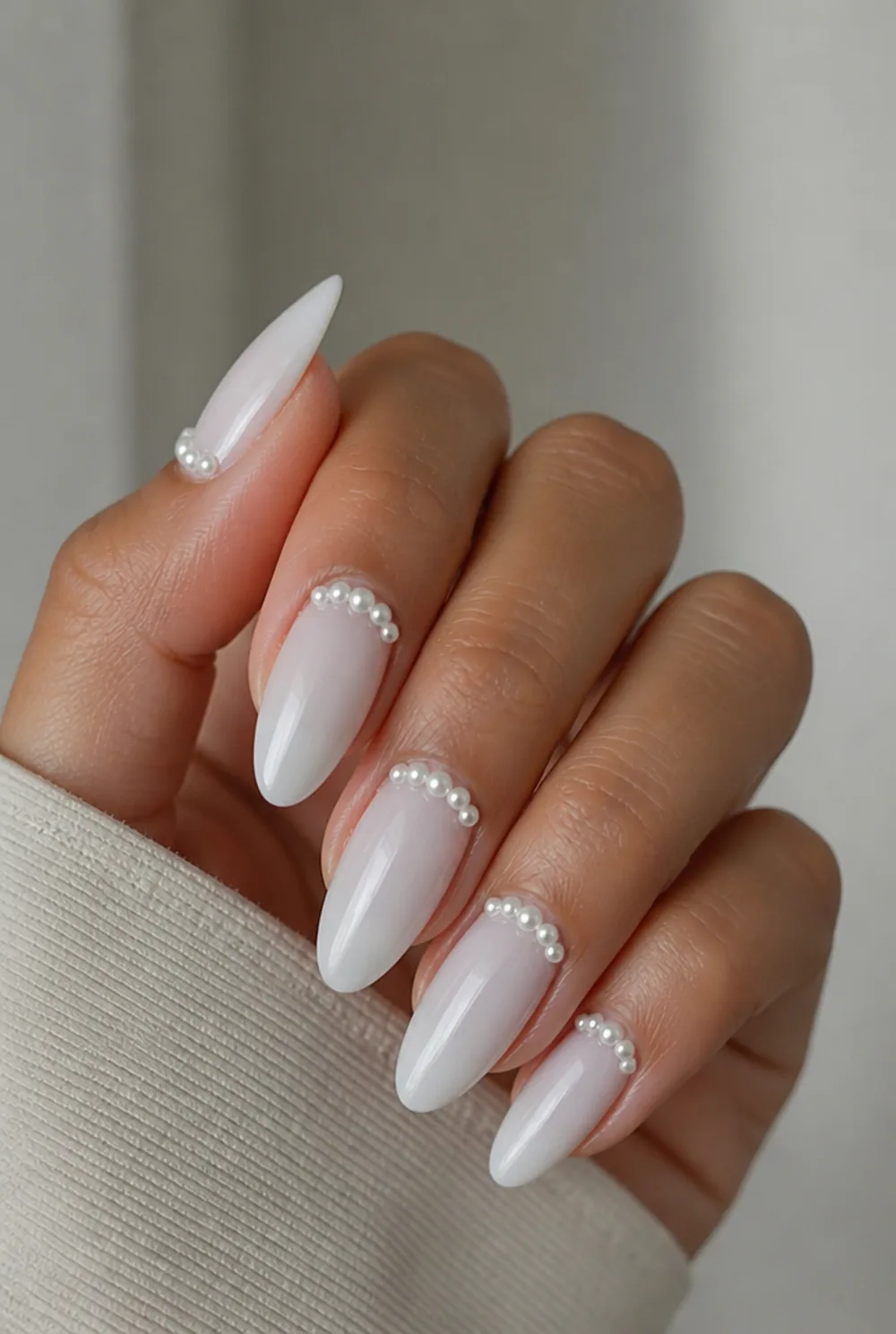 milky white with pearl beads nail art on olive skin, long length