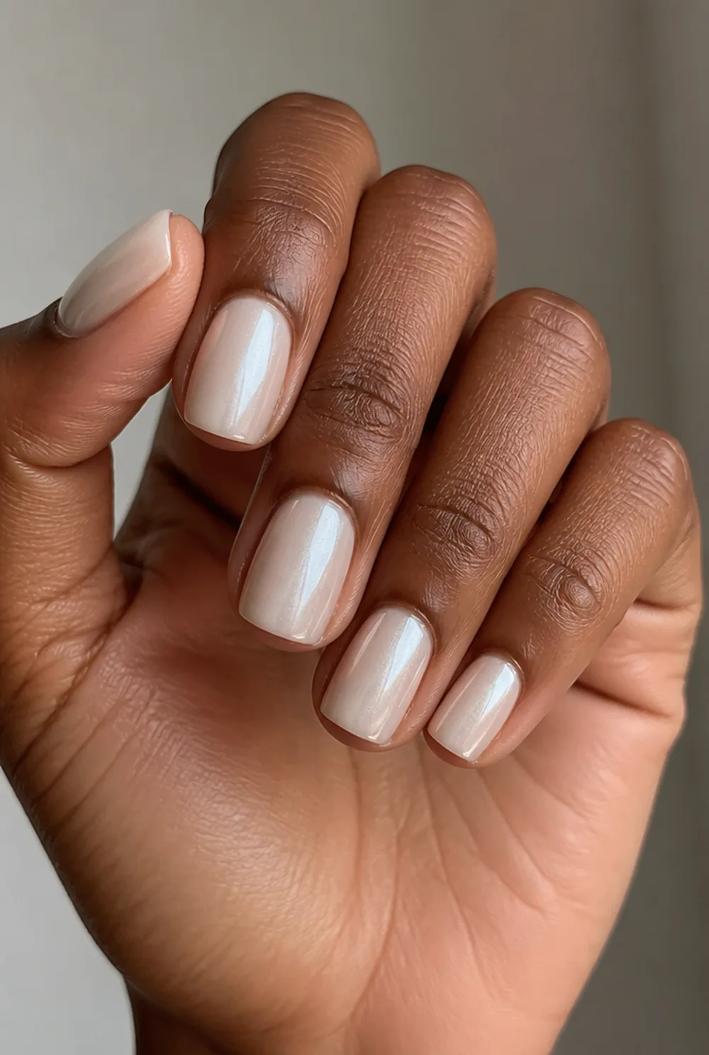 milky white cat eye nail art on deep brown skin