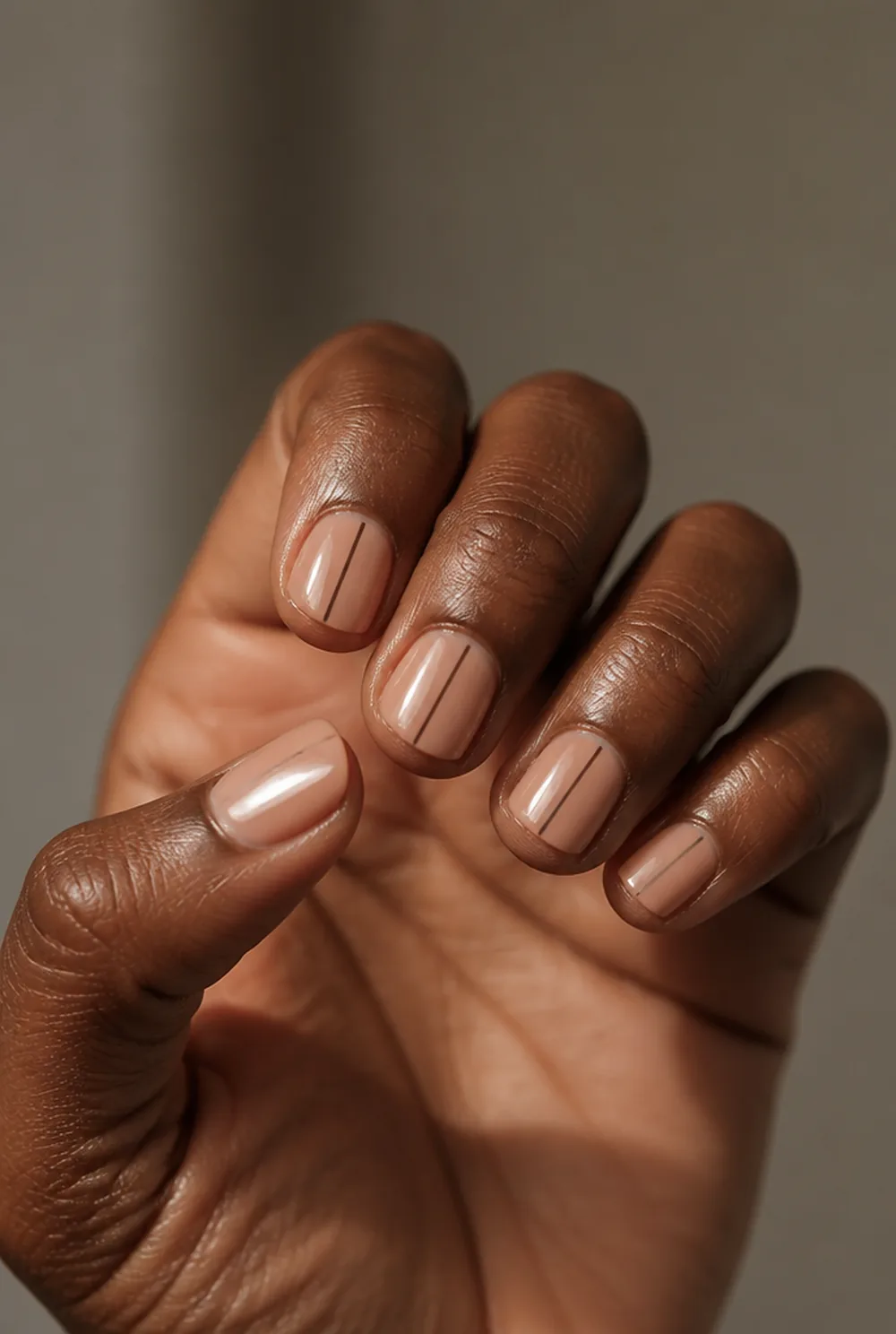 single line down nail art on deep brown skin