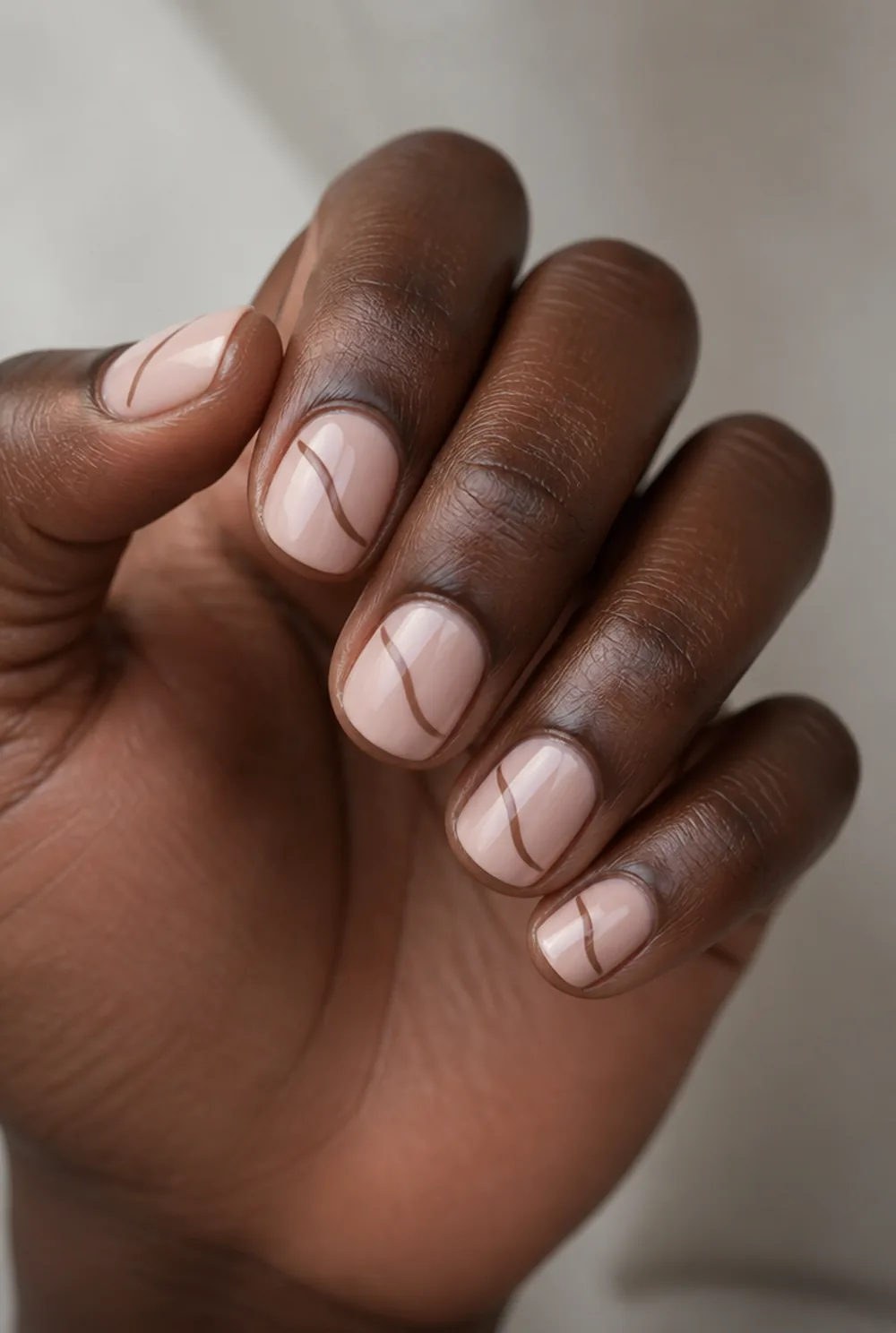single swirl nail art on deep brown skin