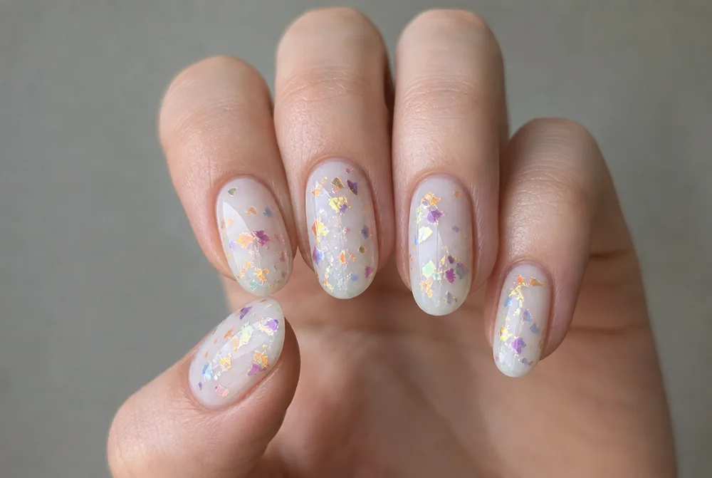 multicolored foil confetti nails on milky white base