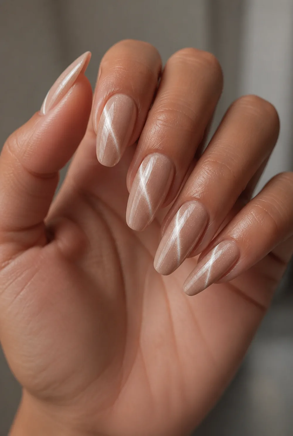 nude cat eye nail art on olive skin, long length