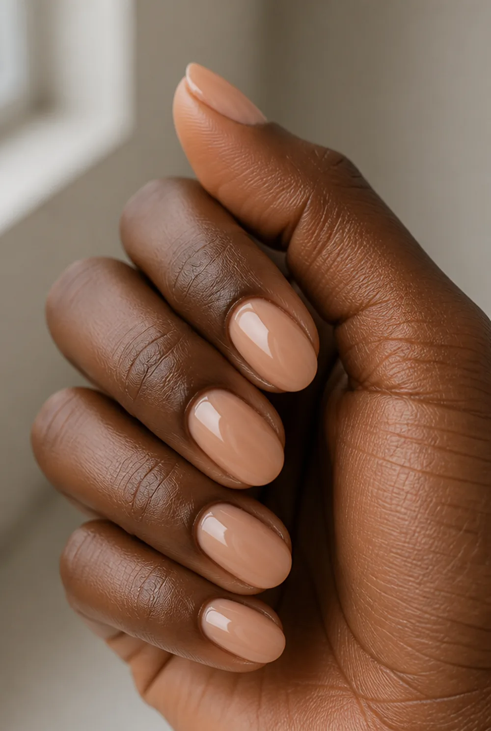 peachy nude nail art on deep brown skin