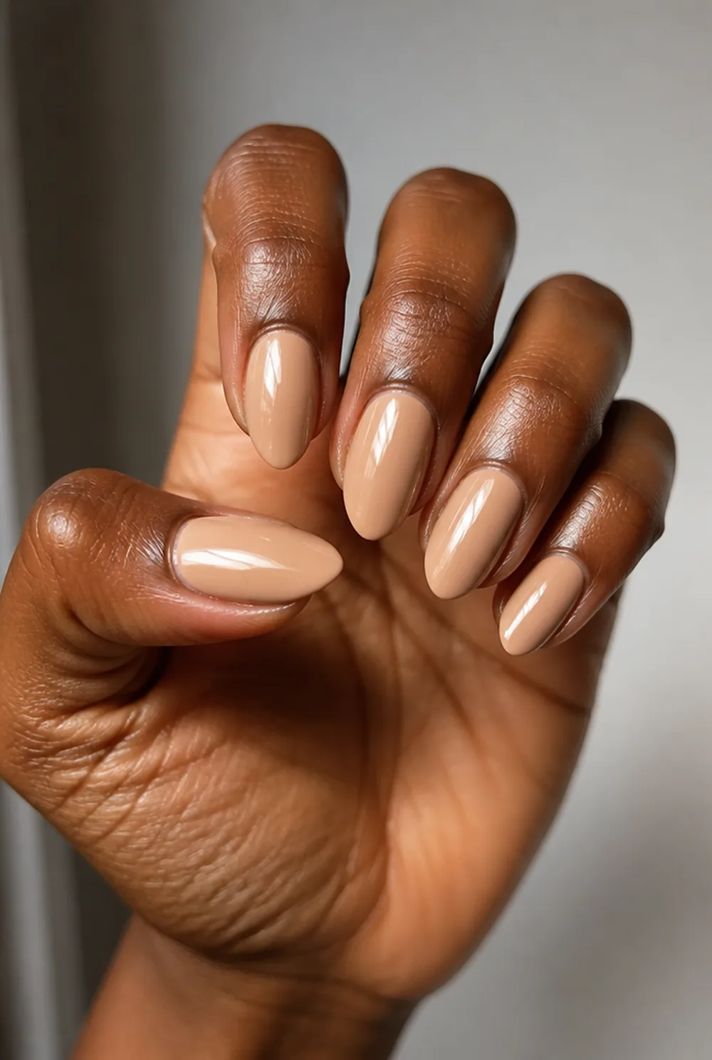 long nude almond nail art on deep brown skin