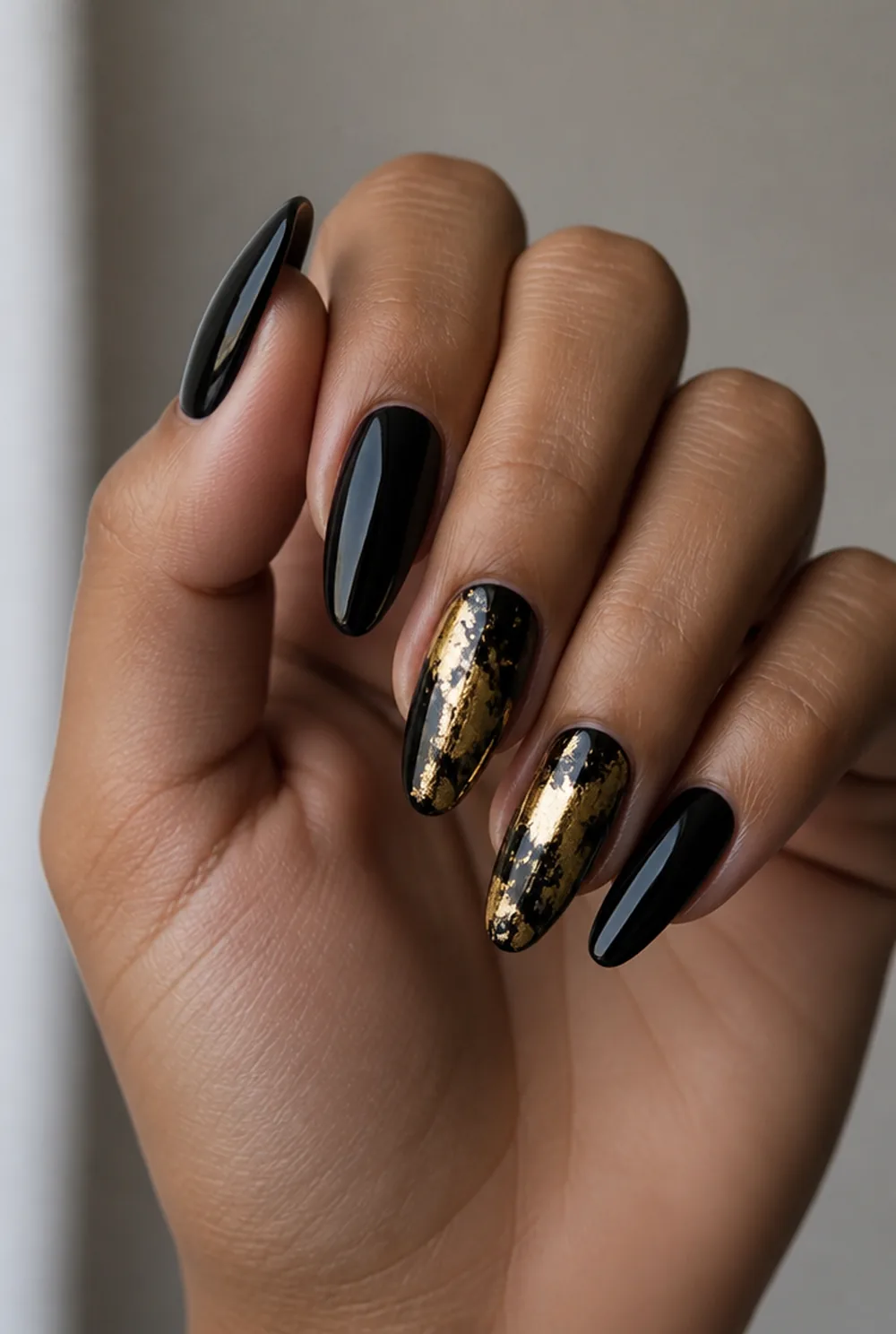 black and gold foil nail art on olive skin, long length