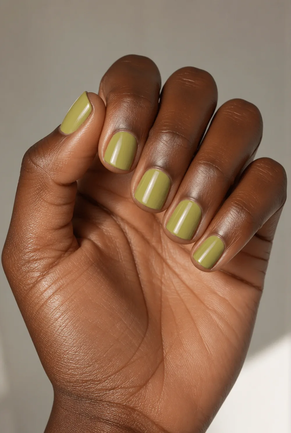 olive nail art on deep brown skin