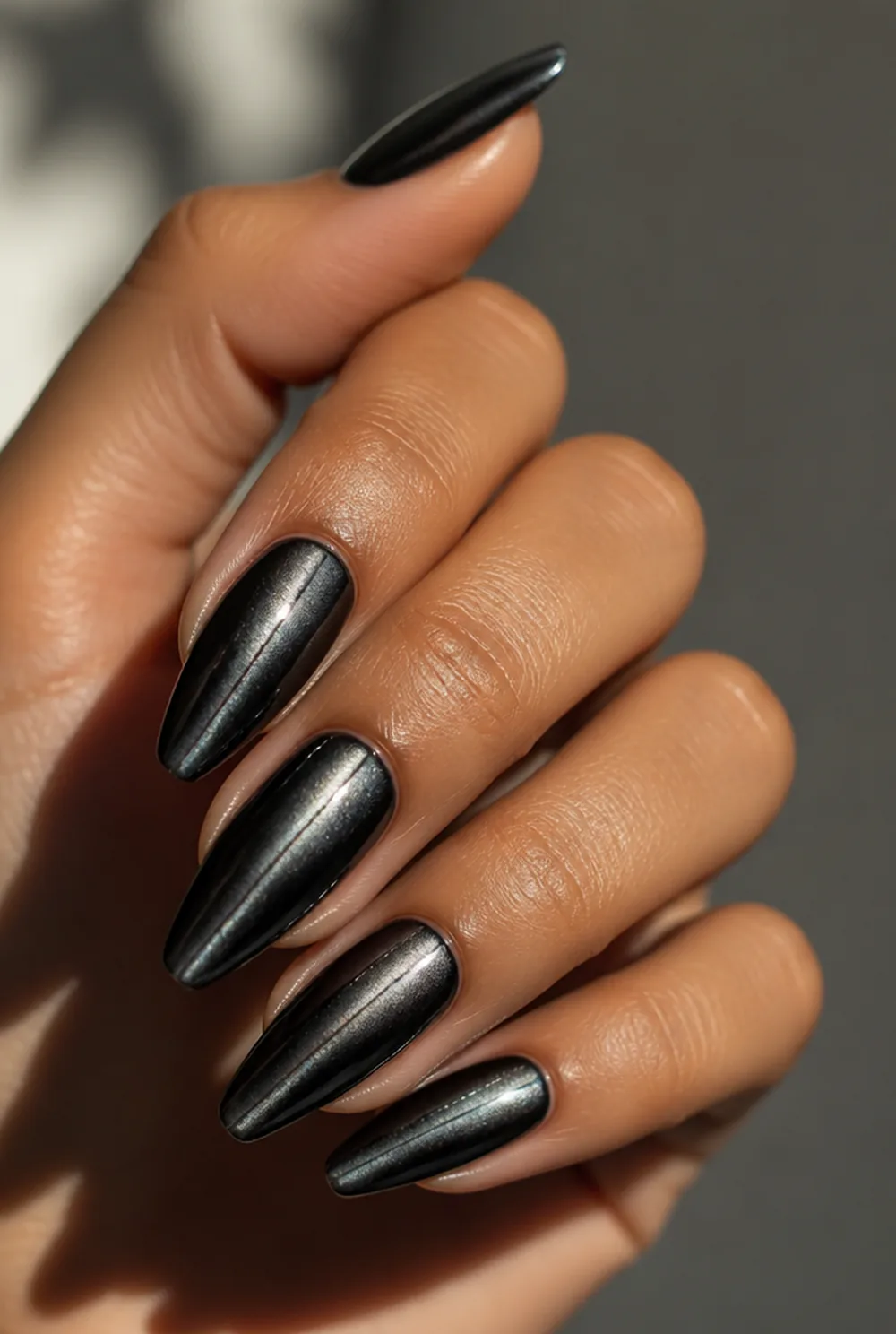 black cat eye nail art on olive skin, long length
