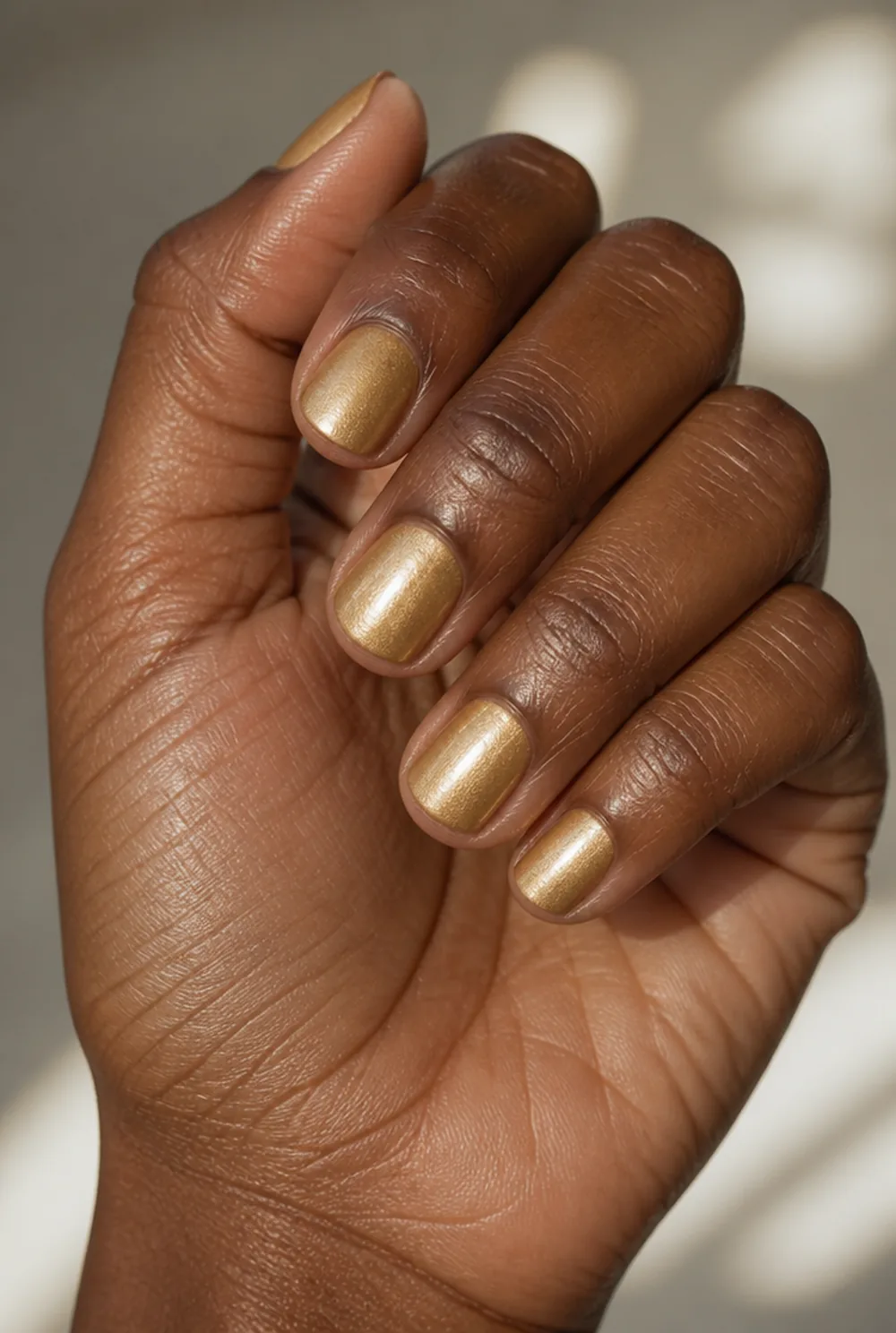 golden amber nail art on deep brown skin
