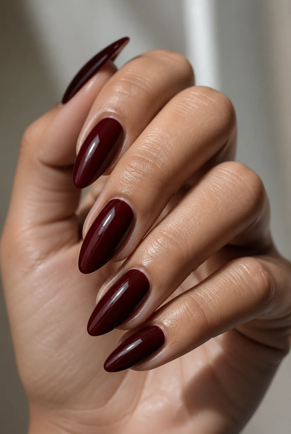 blackened cherry nail art on olive skin, long length