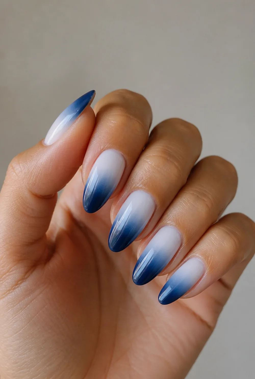 blue ombre nail art on olive skin, long length