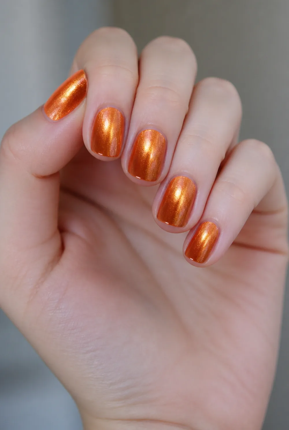 orange chrome nail art on fair skin short length - PolishedAndPrettyNails.com orange chrome nail art on fair skin, short length
