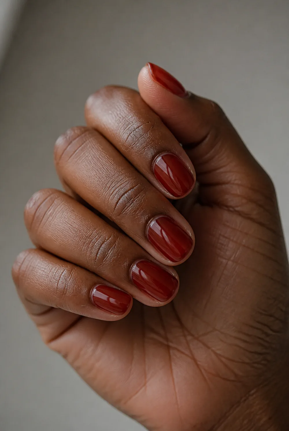 oval jelly red nail art on deep brown skin