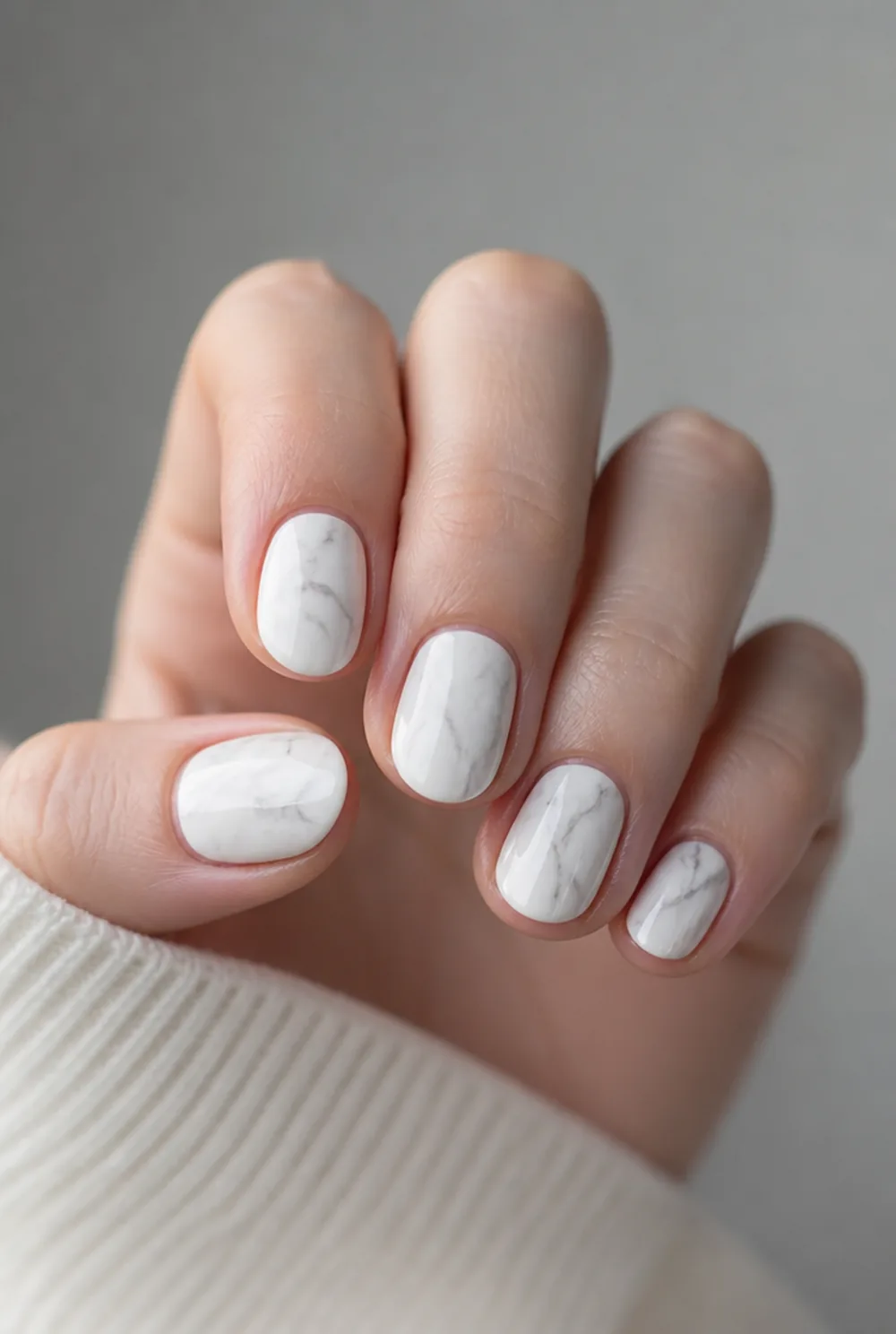 oval marble nail art on fair skin, short length