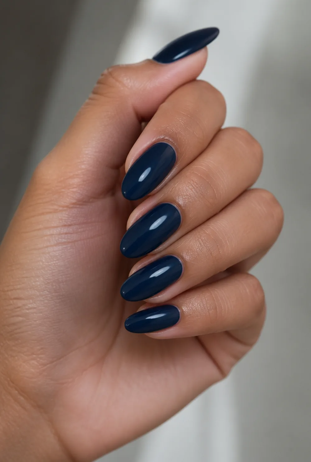 oval navy nail art on olive skin, long length