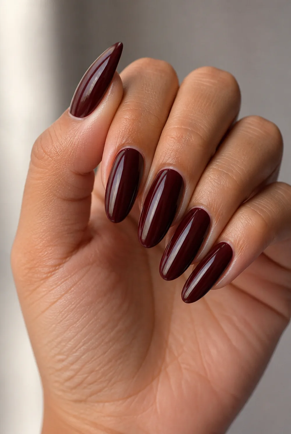 long oval burgundy nail art on olive skin, long length