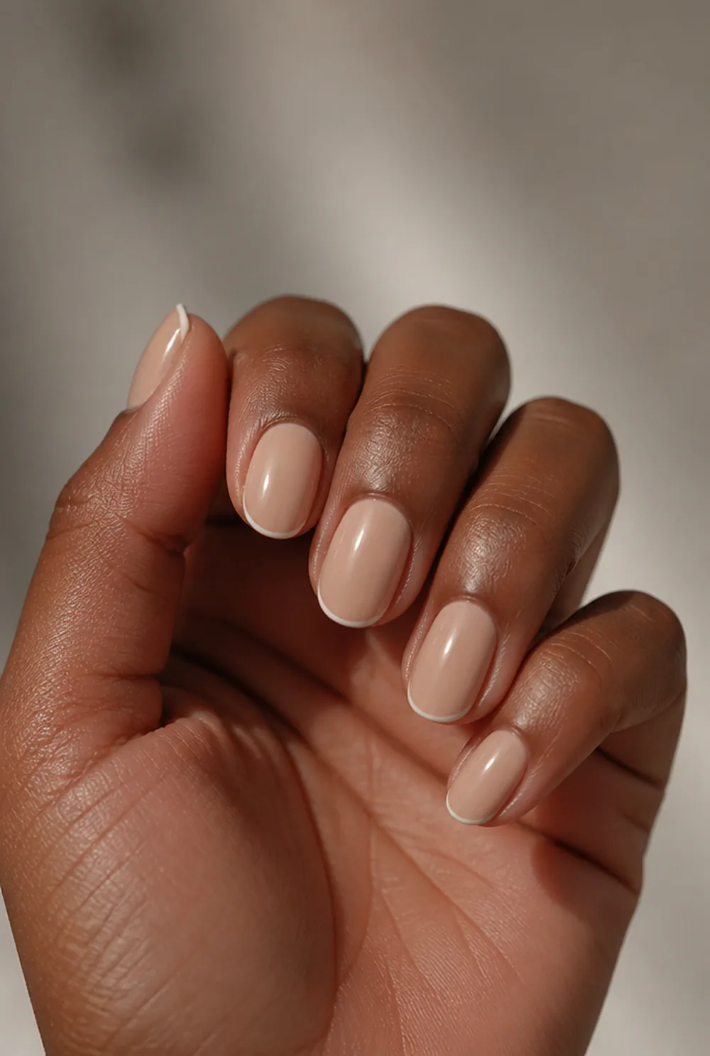 oval nude with micro french nail art on deep brown skin