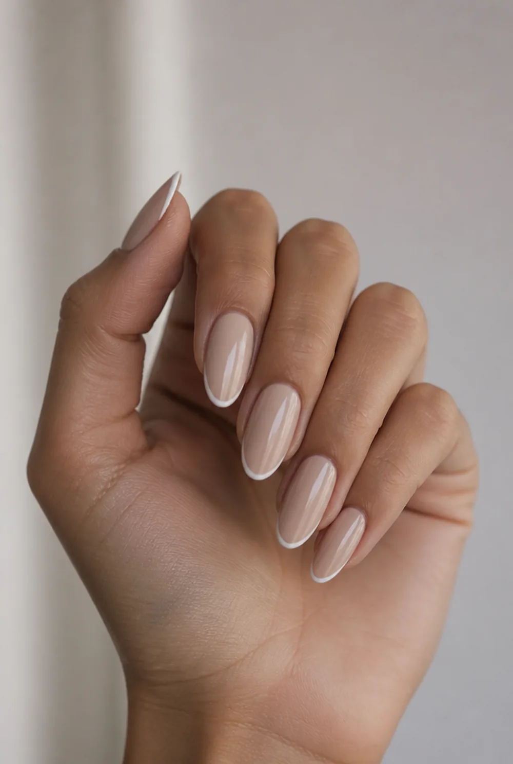 oval nude with micro french nail art on olive skin, long length