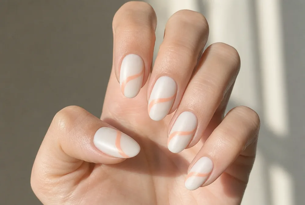peach swirl nail art on milky base