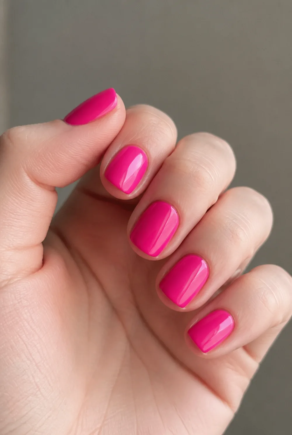 barbie pink square nail art on fair skin, short length