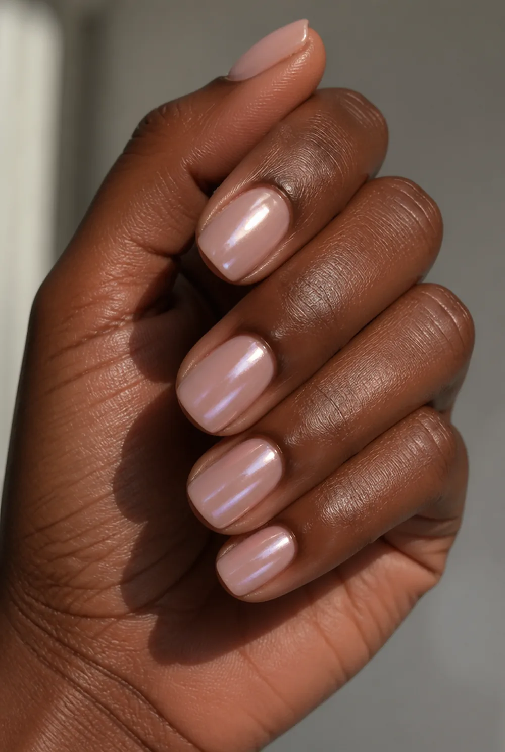 pink glazed donut nail art on deep brown skin