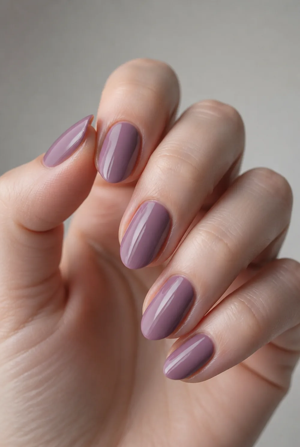 mauve pink nail art on fair skin, short length