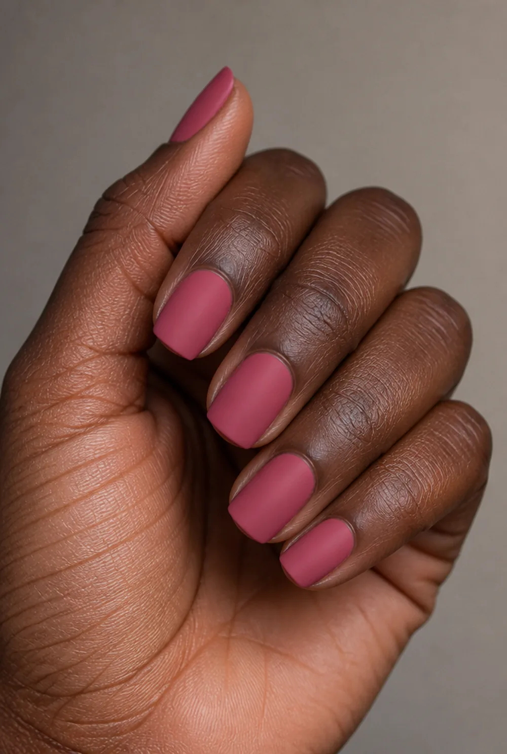 pink velvet matte nail art on deep brown skin