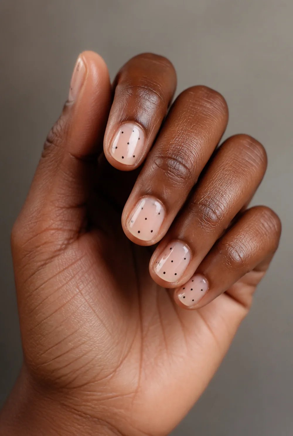 scattered micro dots nail art on deep brown skin