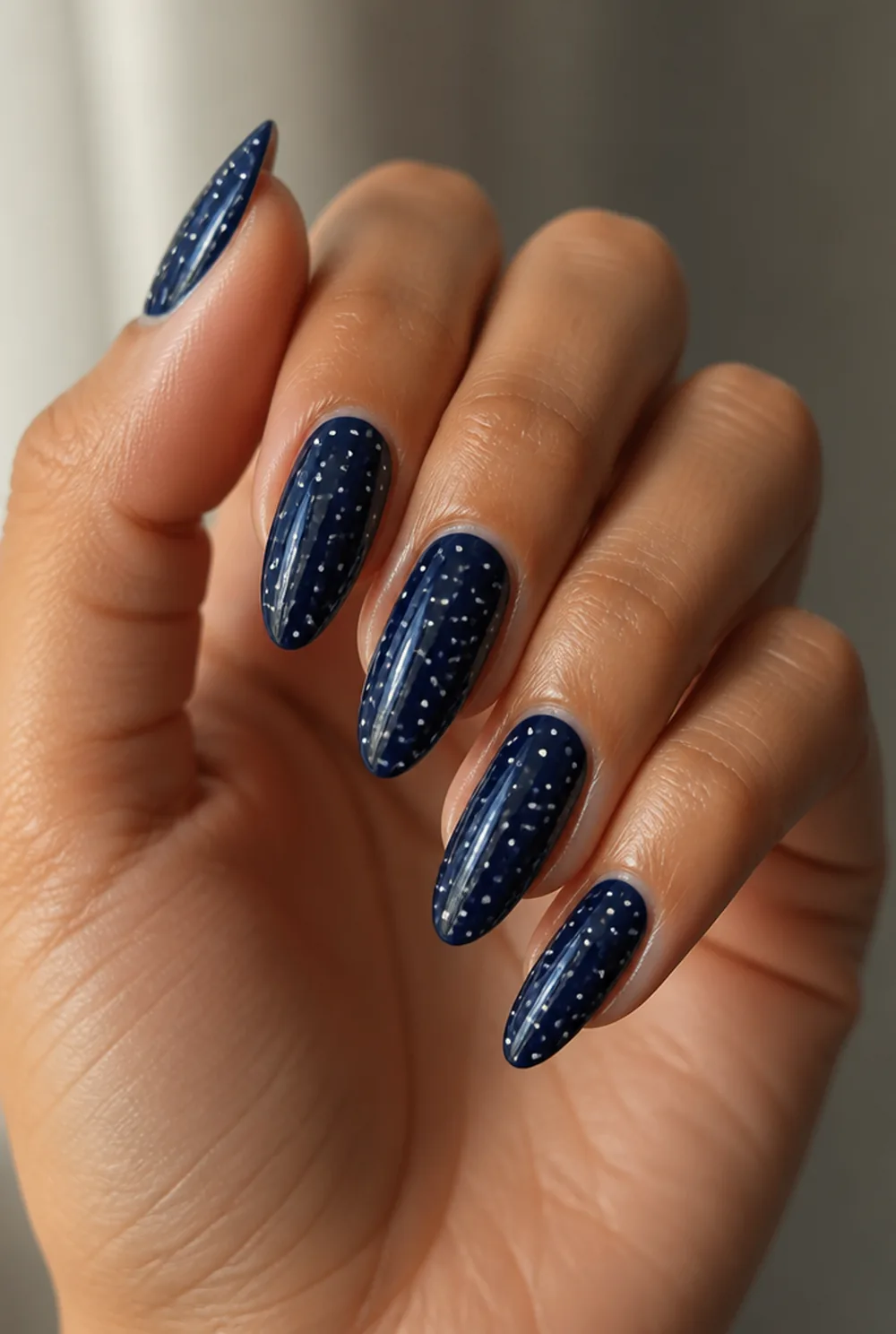 navy with white dots nail art on olive skin, long length