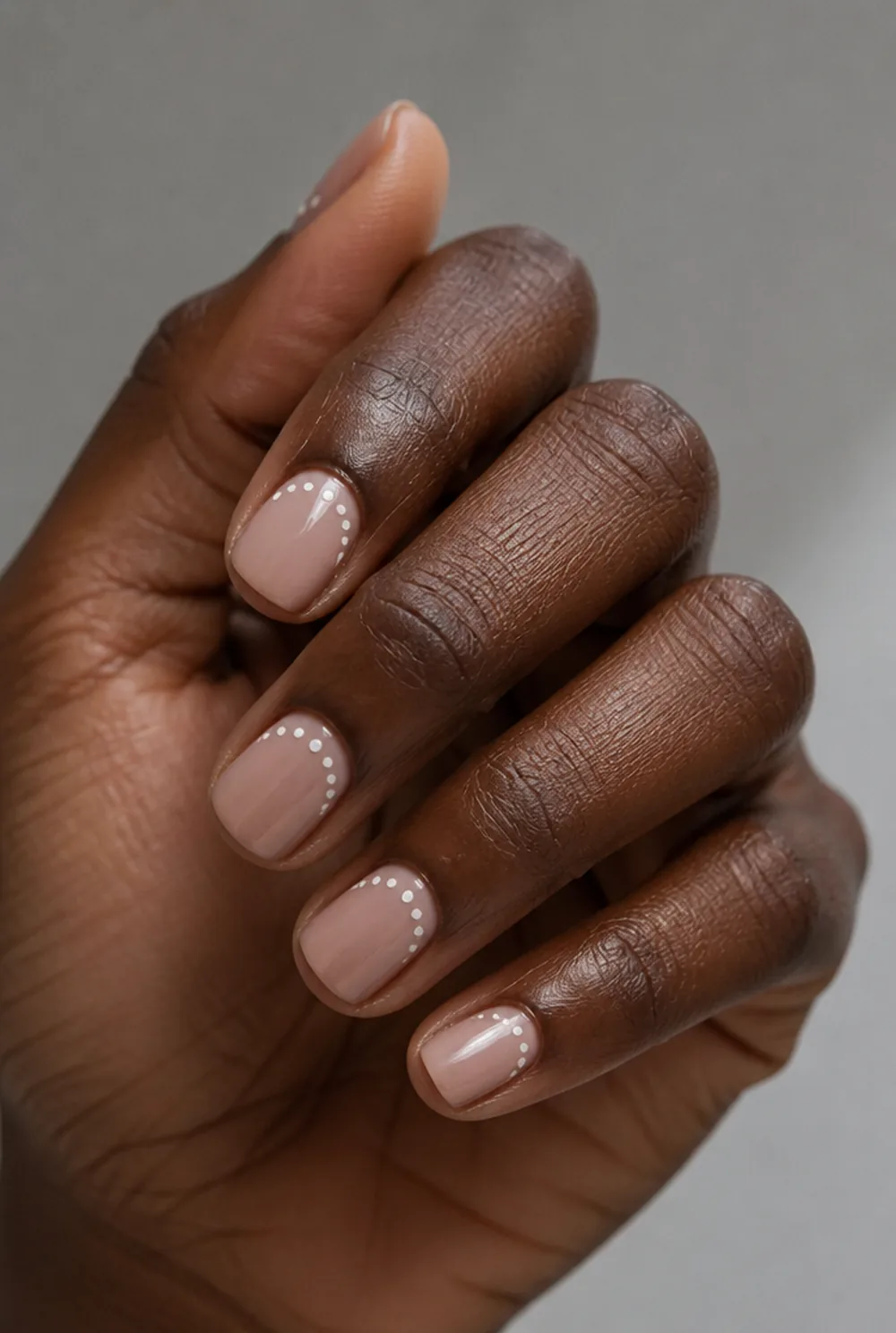 dotted half moon nail art on deep brown skin