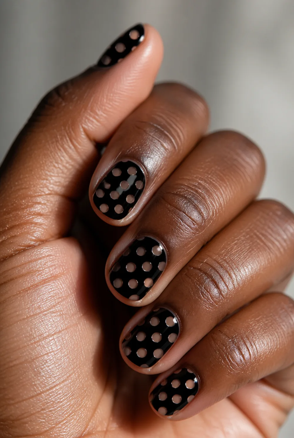 negative space dots nail art on deep brown skin