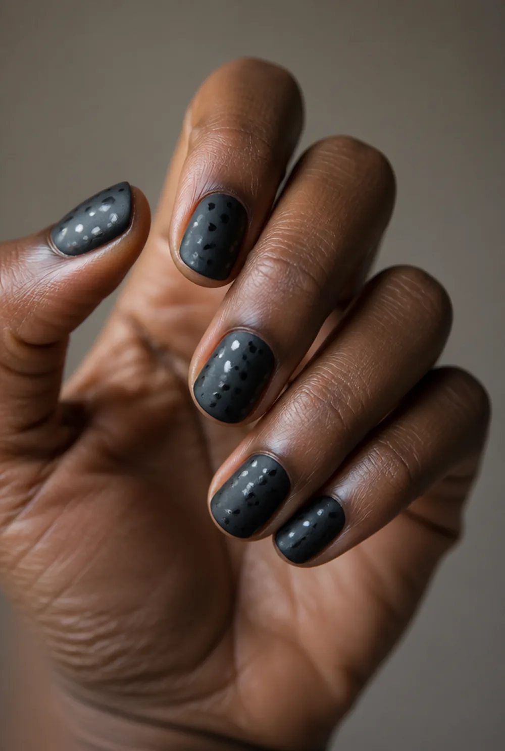 dots over matte nail art on deep brown skin