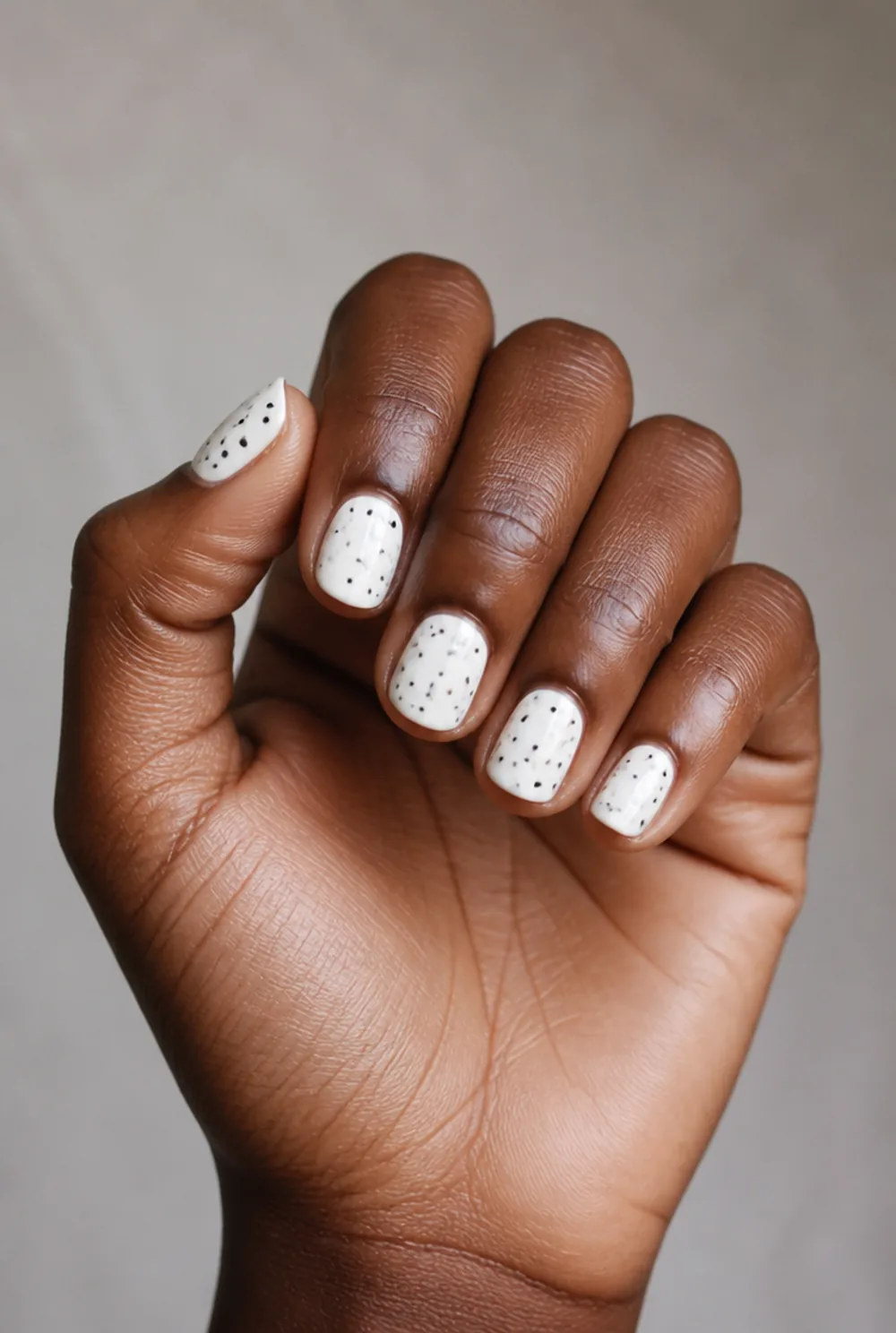 black on white classic nail art on deep brown skin