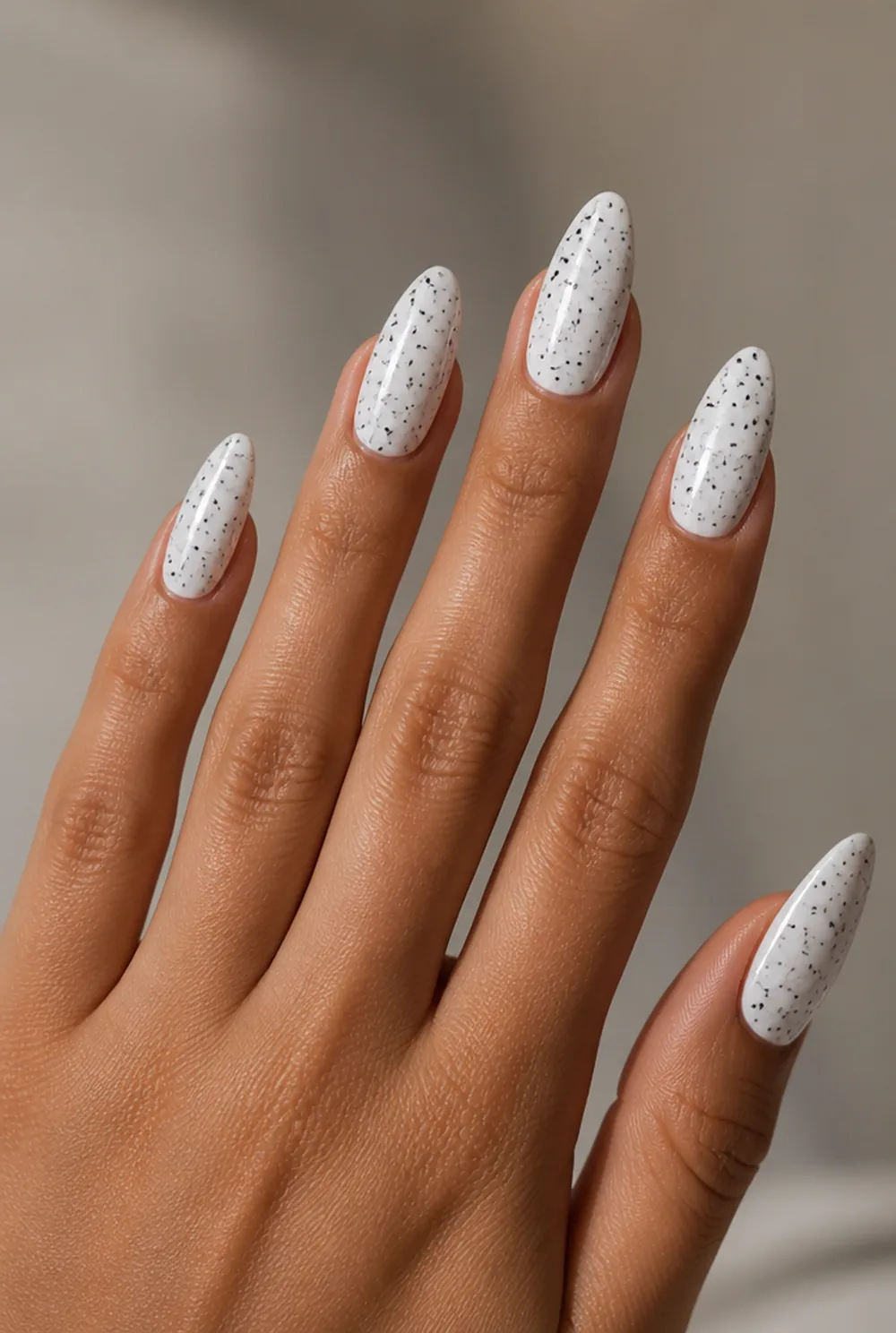 black on white classic nail art on olive skin, long length