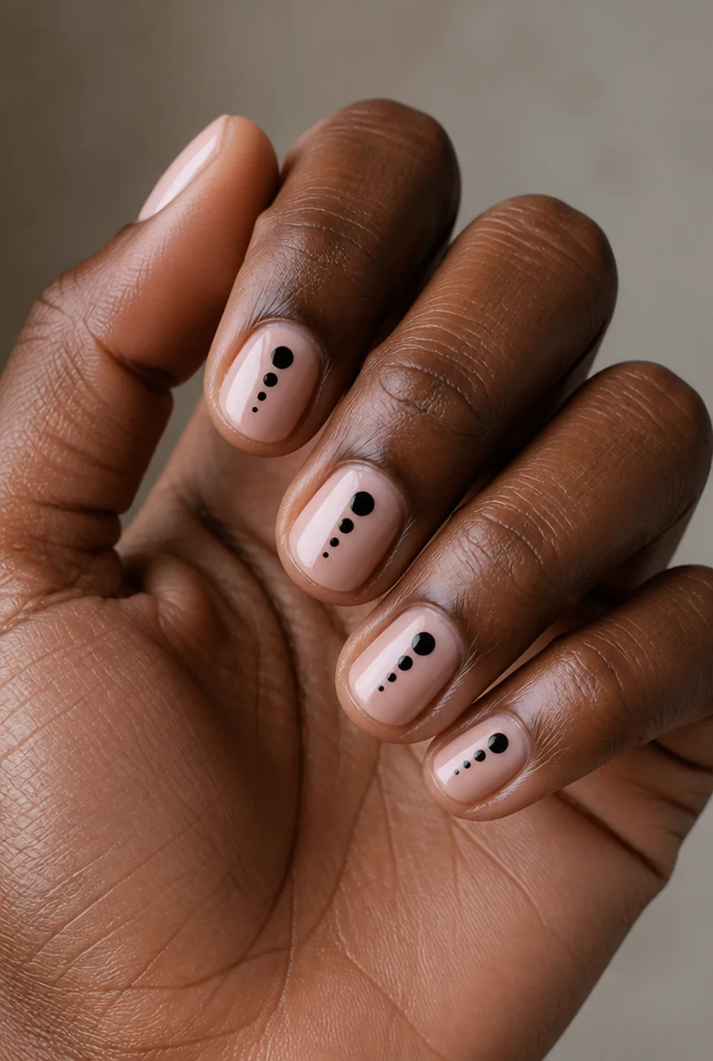 graduated dots nail art on deep brown skin