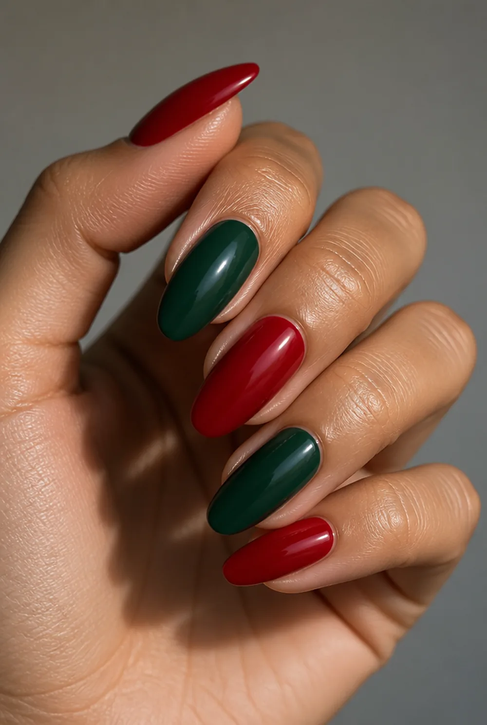 red and green alternating nail art on olive skin, long length