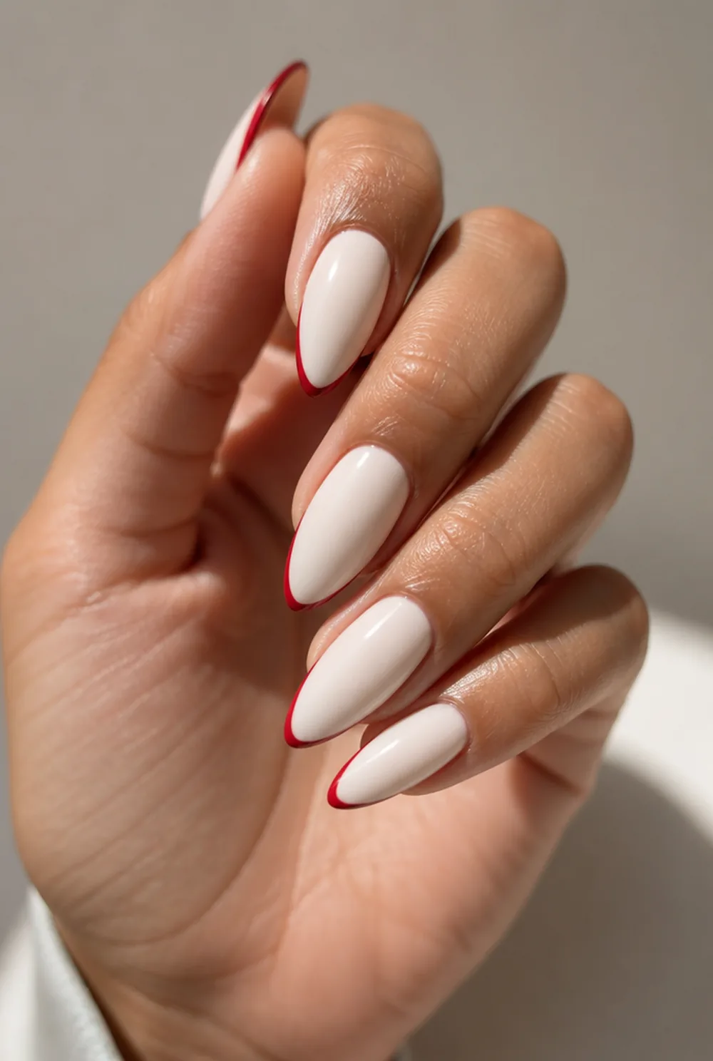 red tips on milky white nail art on olive skin, long length